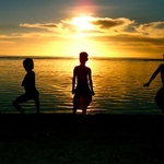 Sunset with children playing in the water